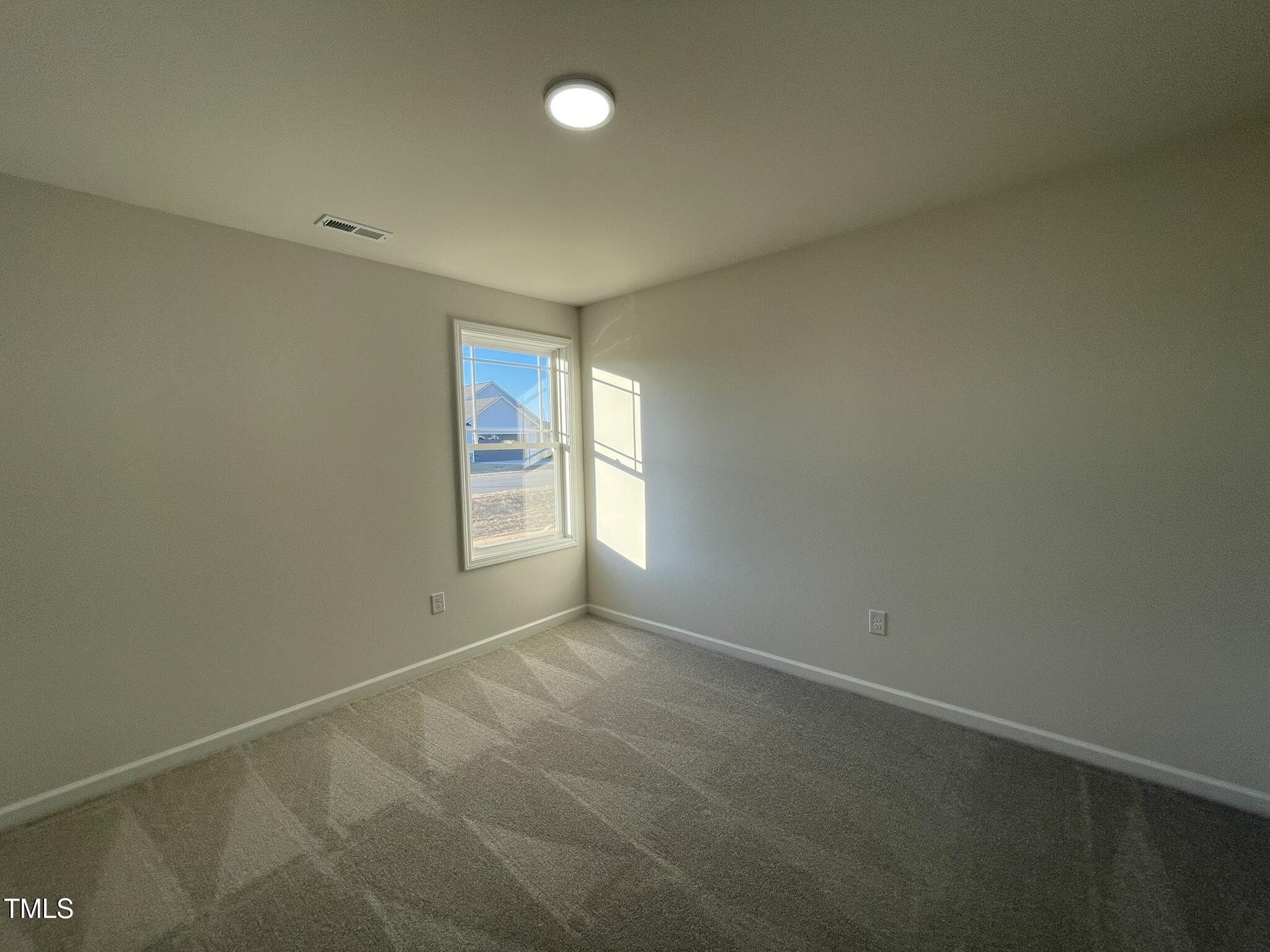 12 Flatland Drive Princeton, NC 27569 - Photo 10 of 20 an empty room with windows