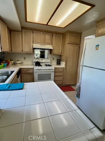 a kitchen with cabinets and appliances