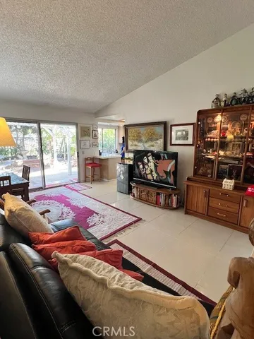 a bedroom with furniture and a flat screen tv