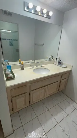 a bathroom with a sink vanity and mirror