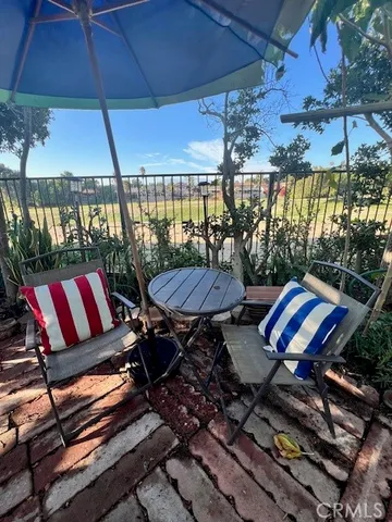 a balcony with a table and chairs