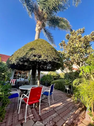 a view of patio with table and chairs under an umbrella