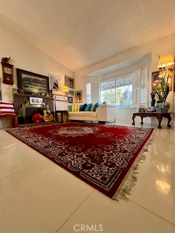 a large bed in a living room next to a window