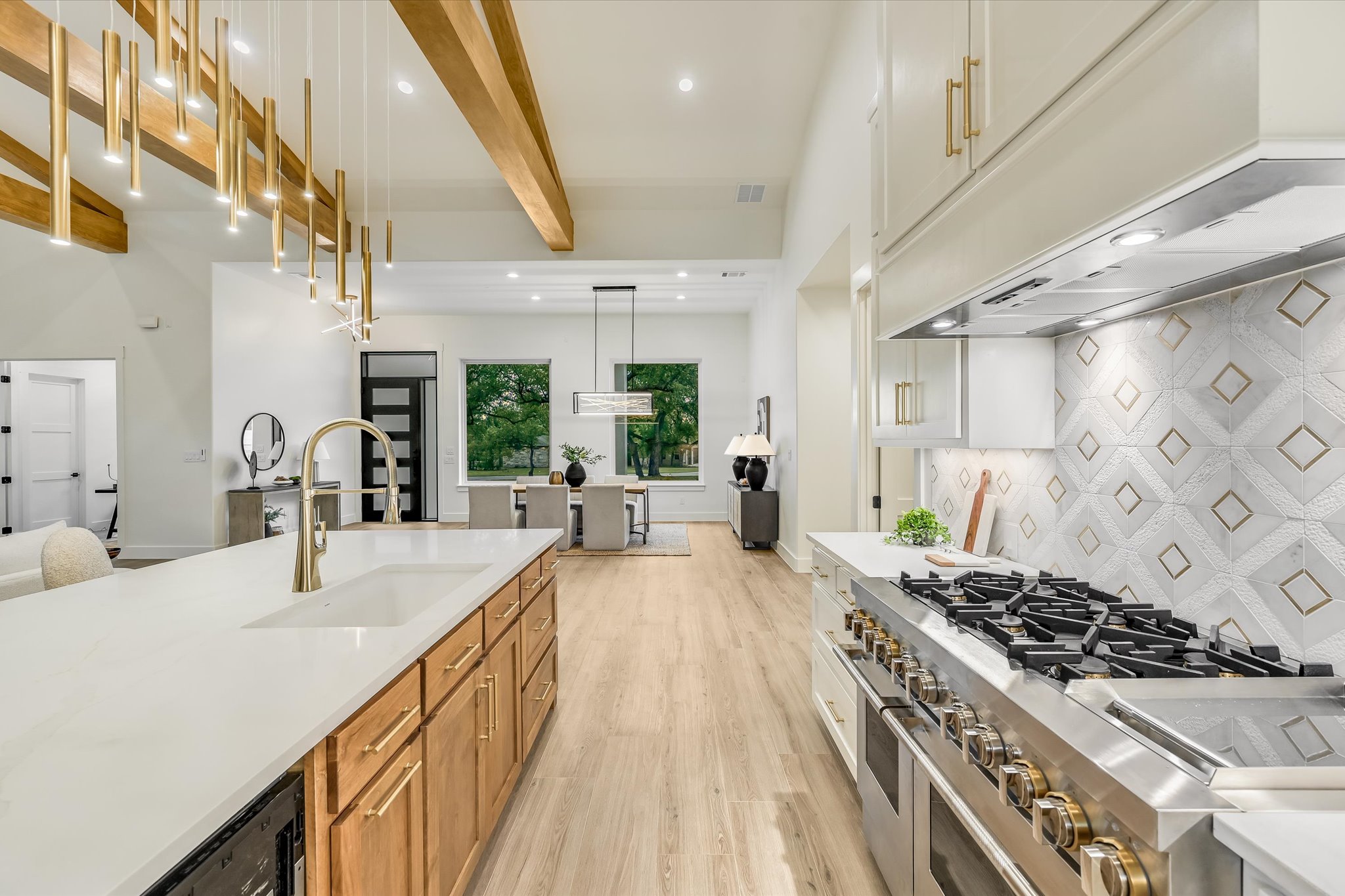 410 Shady Tree Drive Georgetown, TX 78633 - Photo 12 of 40 Kitchen featuring two tone cabinetry, range with two ovens, beamed ceiling, light wood-style flooring, and pendant lighting