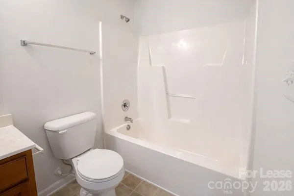 a white toilet sitting next to a bath tub shower