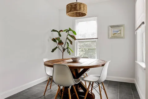 a dining room with furniture and window