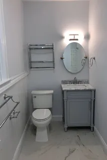 a bathroom with a toilet sink and mirror