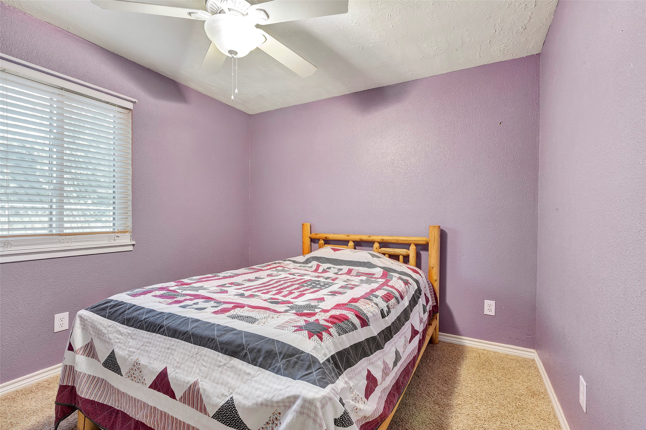 302 Walnut Cove Road Onalaska, TX 77360 - Photo 16 of 25 a bedroom with a bed and a chandelier
