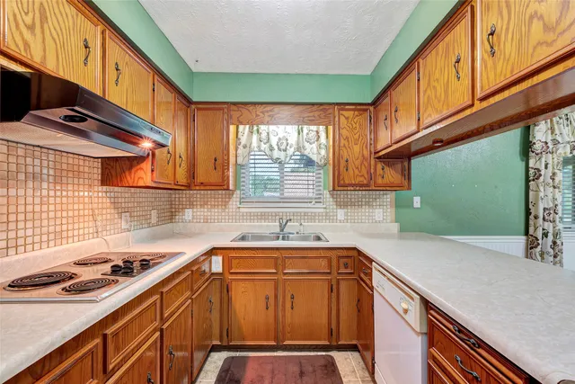 a kitchen that has a sink and a stove in it