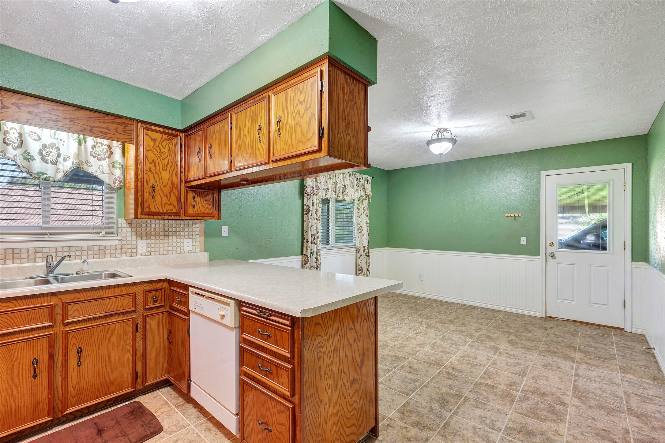 302 Walnut Cove Road Onalaska, TX 77360 - Photo 8 of 25 a kitchen with a sink cabinets and window