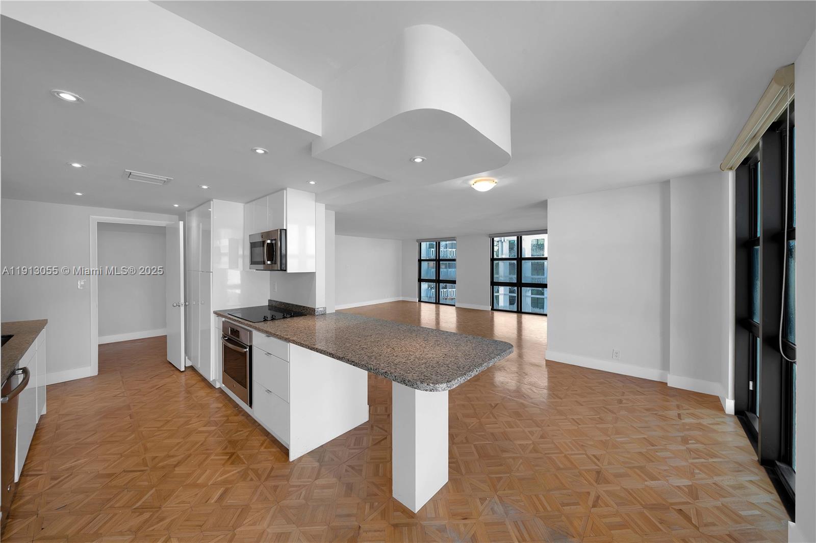 a kitchen with stainless steel appliances granite countertop a refrigerator and a stove top oven
