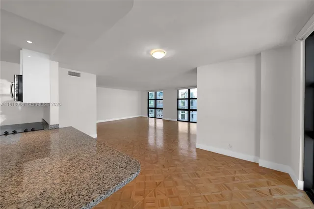 a view of a kitchen with a sink and cabinets