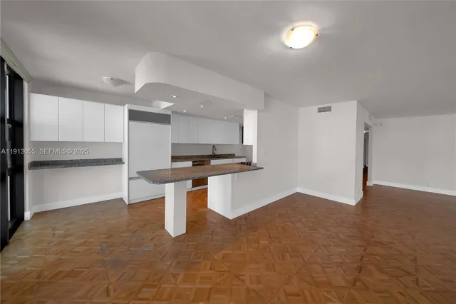 a view of kitchen with refrigerator sink and stove