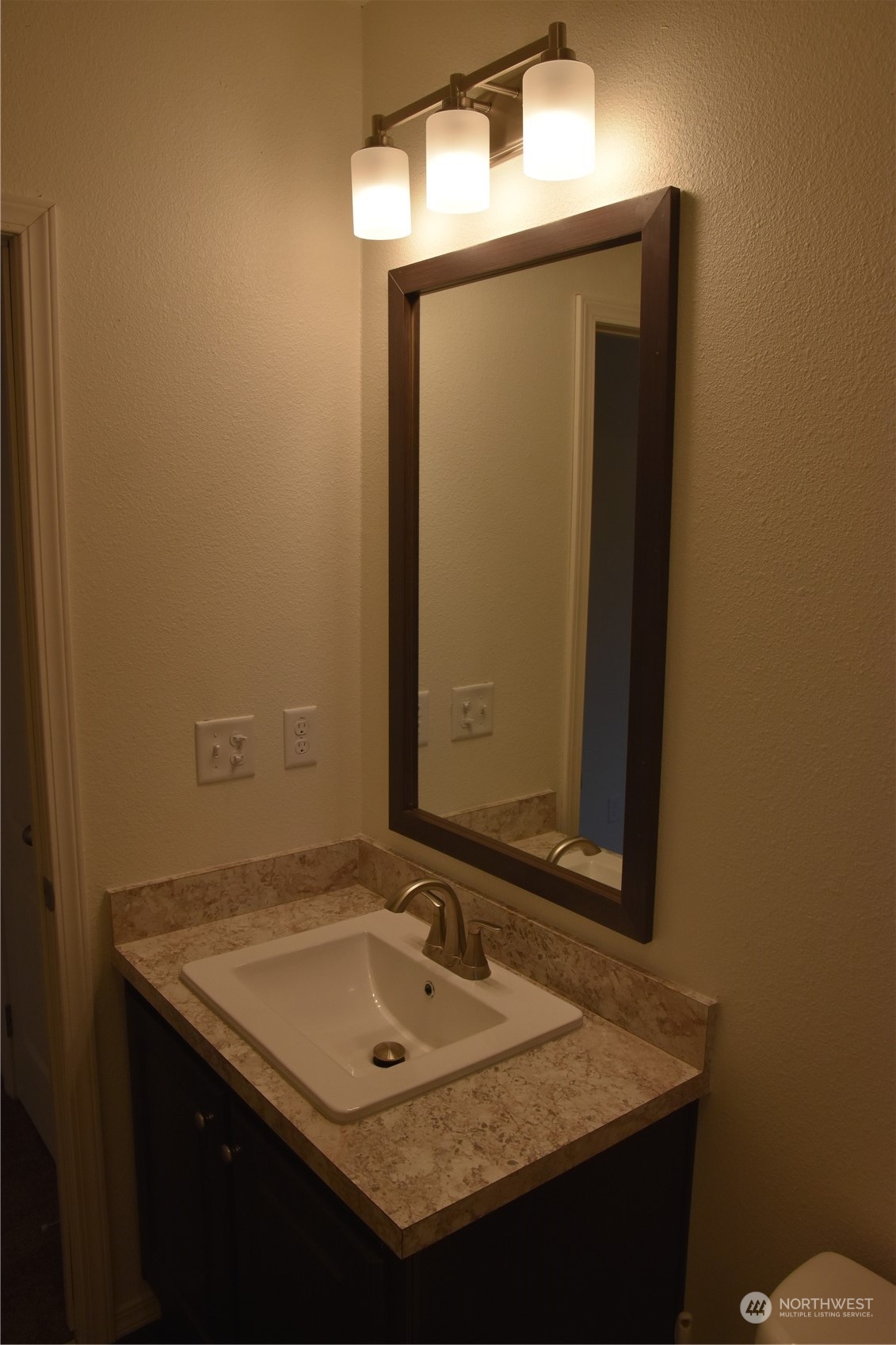 4322 Ocean Beach Highway Longview, WA 98632 - Photo 15 of 19 a bathroom with a granite countertop sink and a mirror