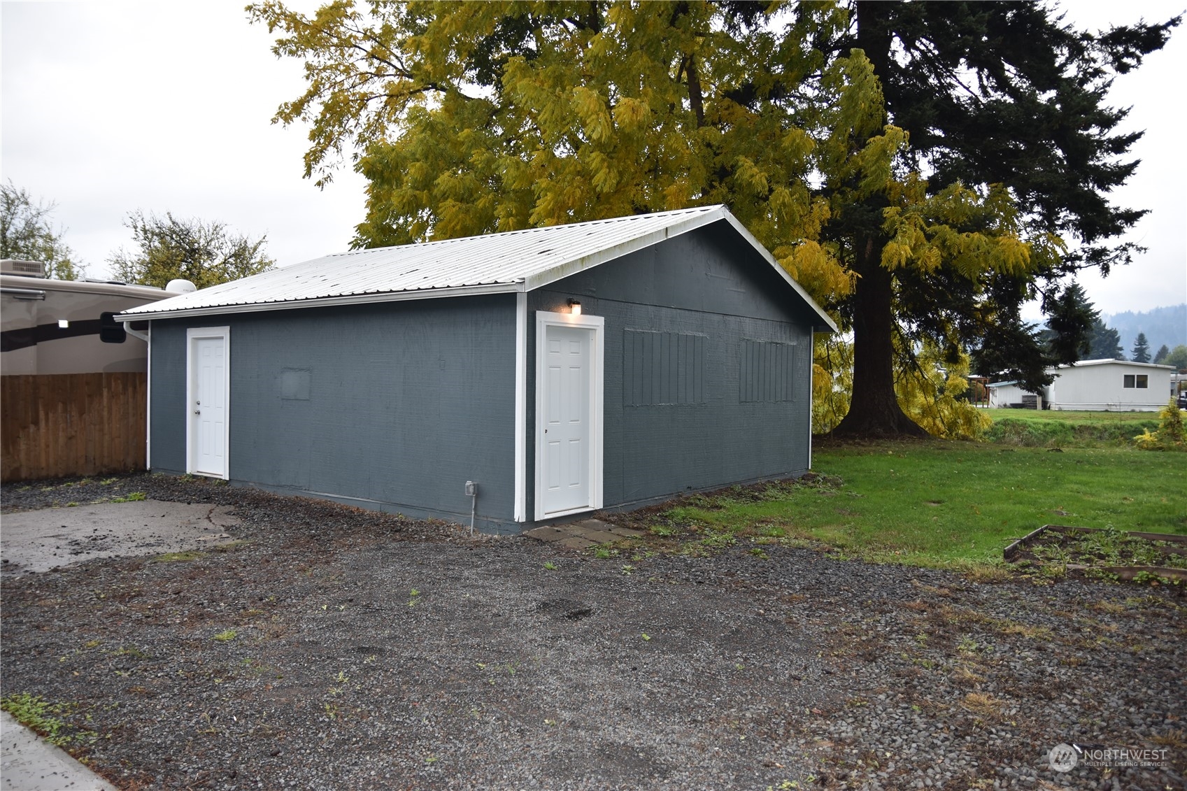 4322 Ocean Beach Highway Longview, WA 98632 - Photo 2 of 19 a backyard of a house with plants and large tree