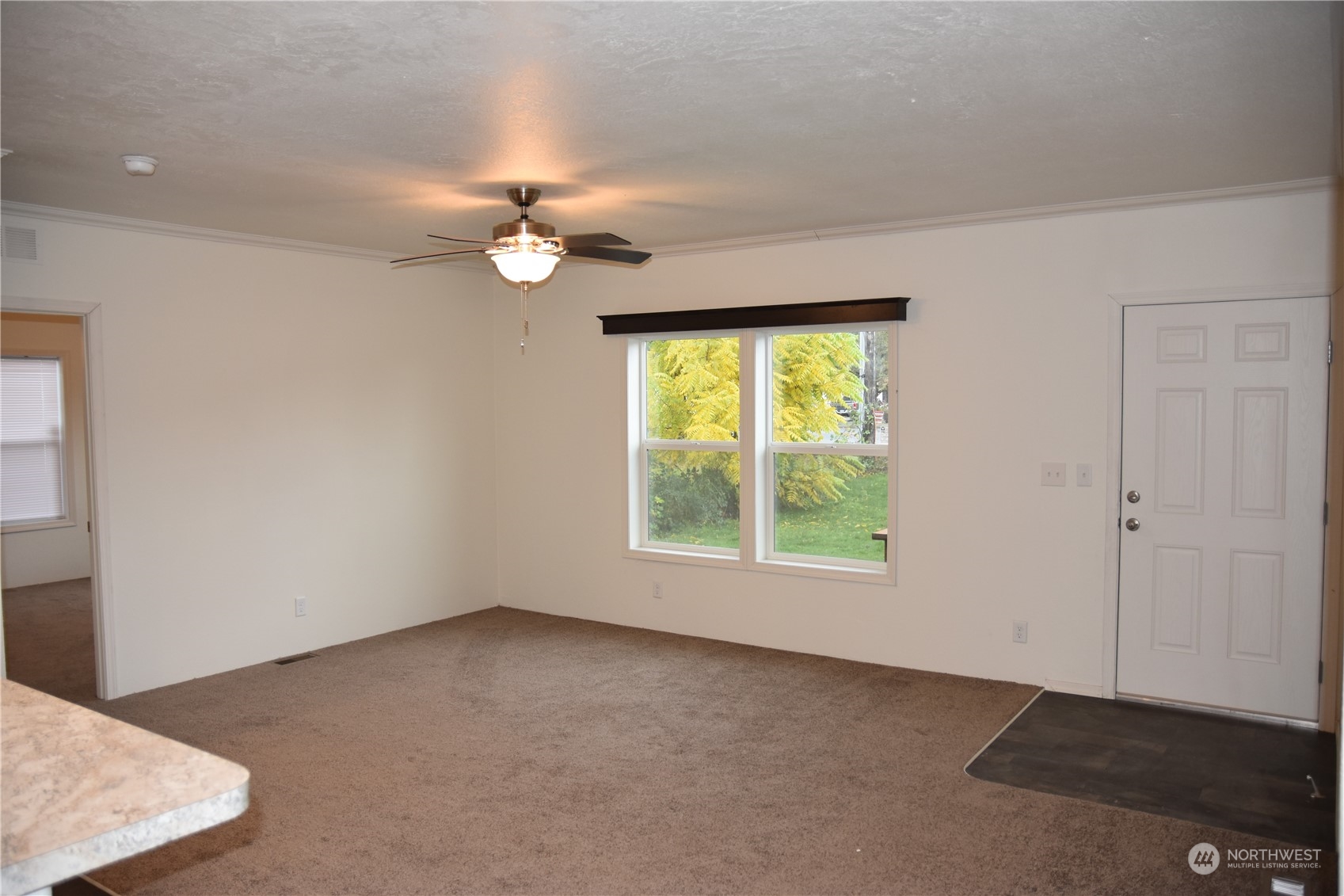 4322 Ocean Beach Highway Longview, WA 98632 - Photo 3 of 19 an empty room with windows and fan