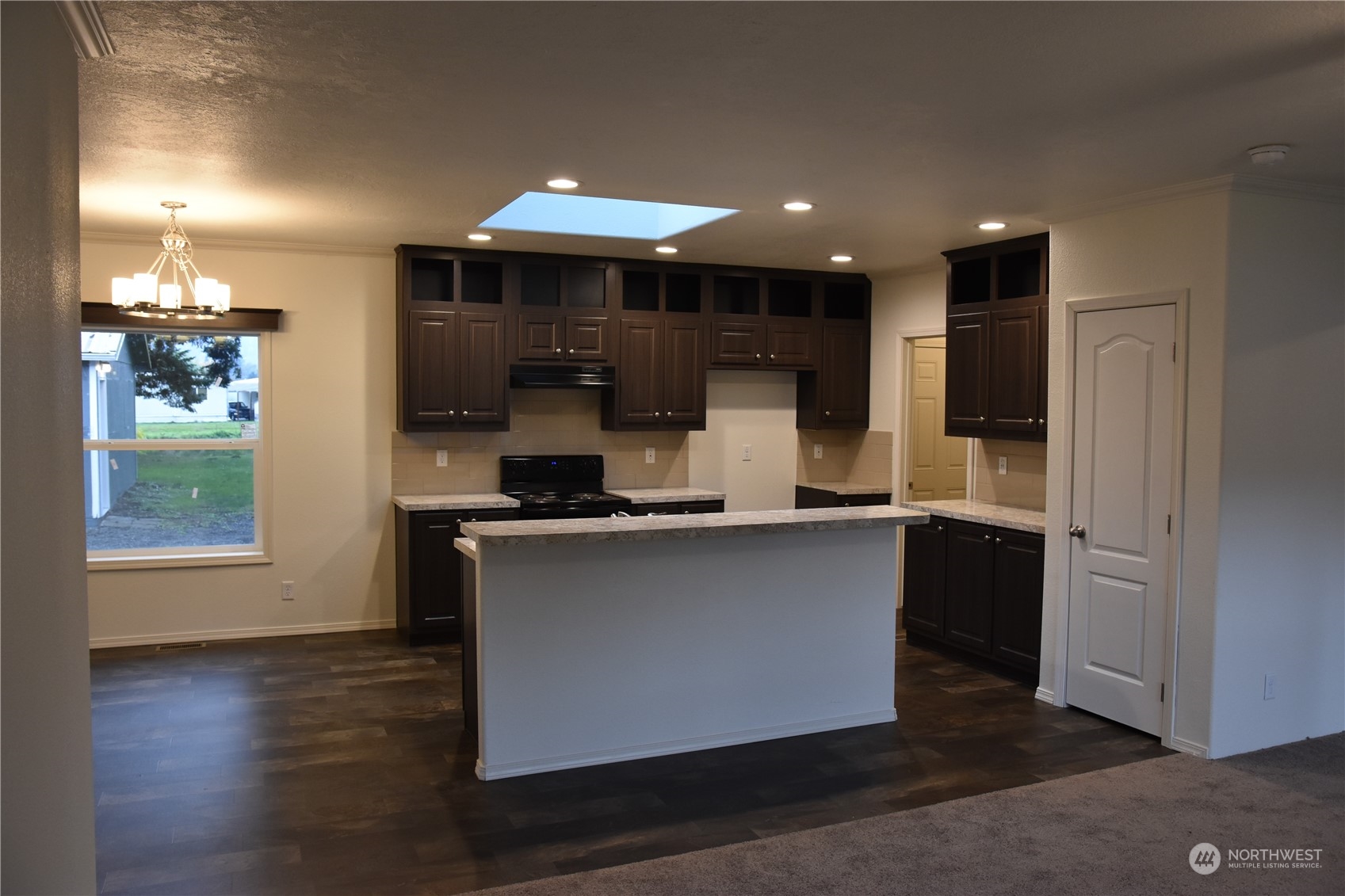 4322 Ocean Beach Highway Longview, WA 98632 - Photo 4 of 19 a kitchen with stainless steel appliances granite countertop a sink a stove and a refrigerator