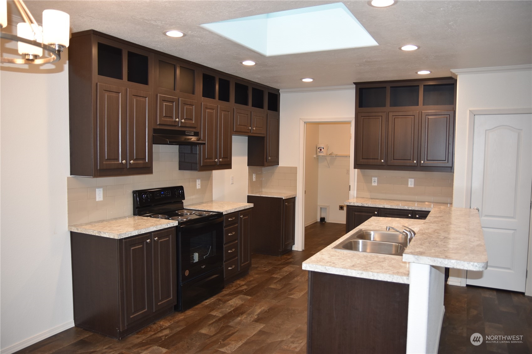 4322 Ocean Beach Highway Longview, WA 98632 - Photo 5 of 19 a kitchen with a sink a stove and refrigerator