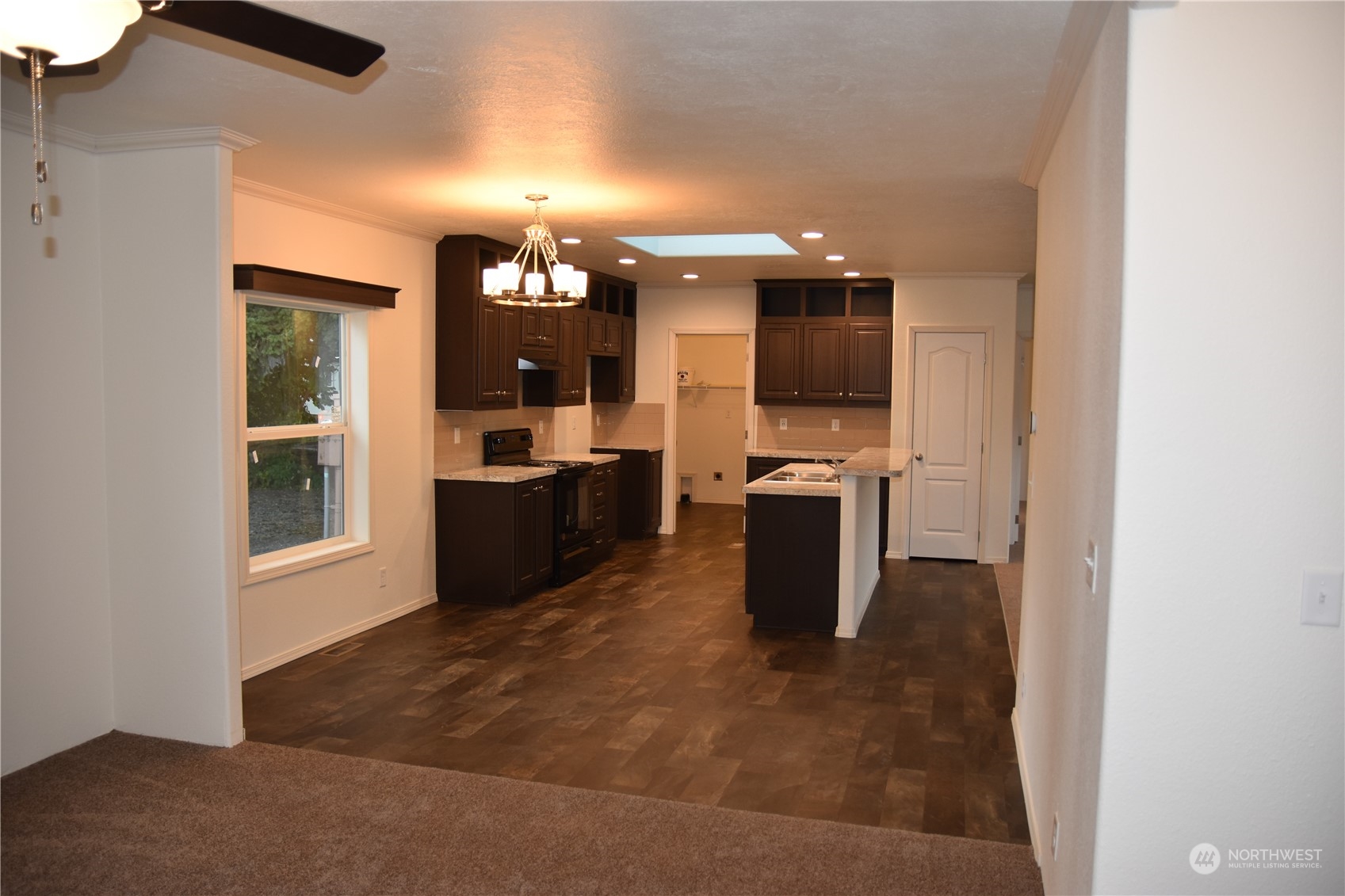 4322 Ocean Beach Highway Longview, WA 98632 - Photo 8 of 19 a kitchen with granite countertop a refrigerator and a stove top oven