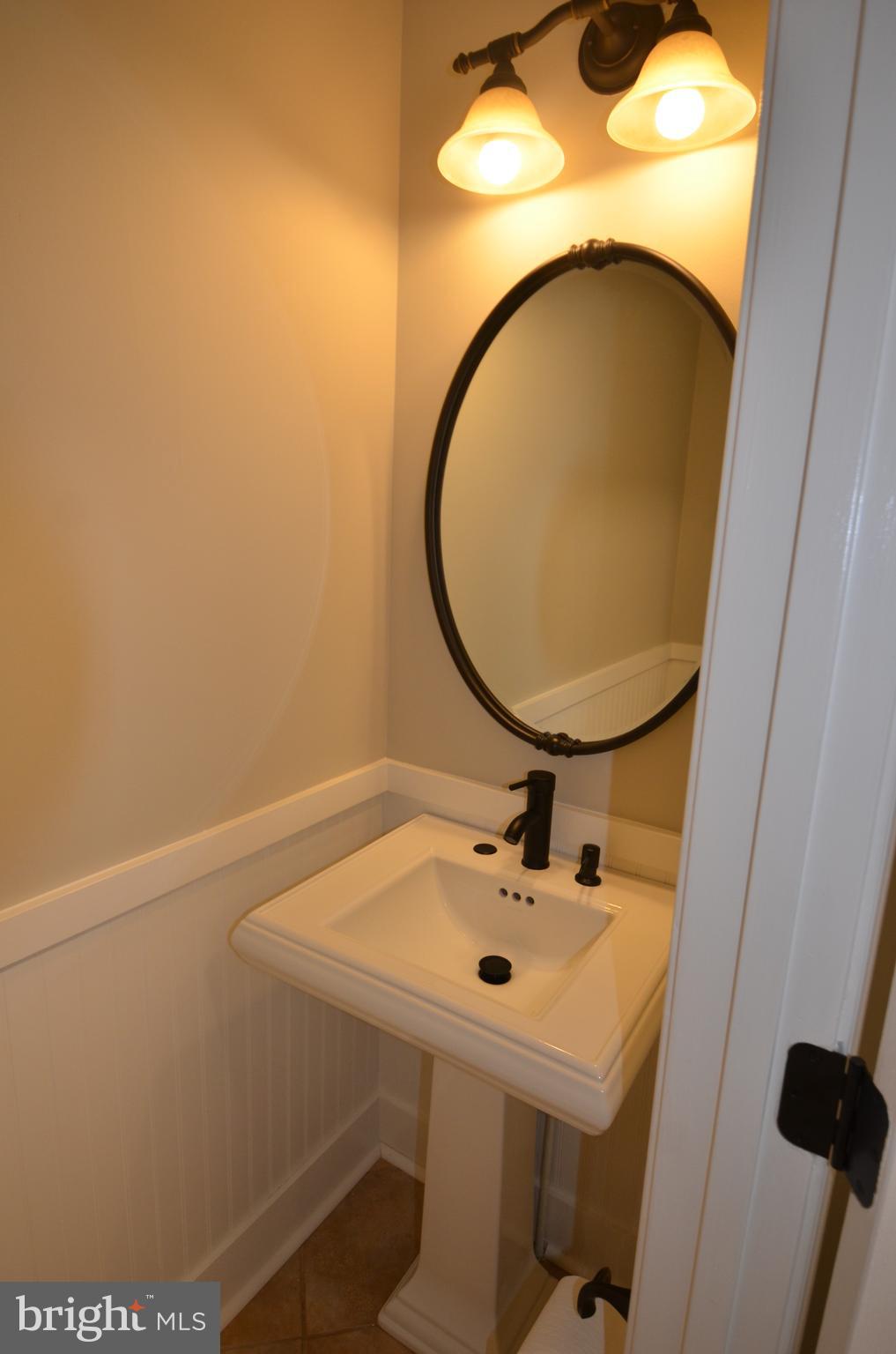 7559 Westmore Drive Springfield, VA 22150 - Photo 15 of 42 Powder Room with bronze fixtures off kitchen