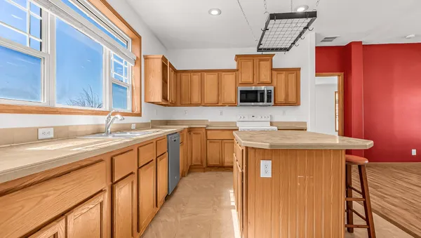 a kitchen that has a sink and a stove in it