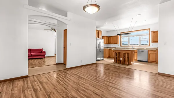an empty room with wooden floor and fireplace
