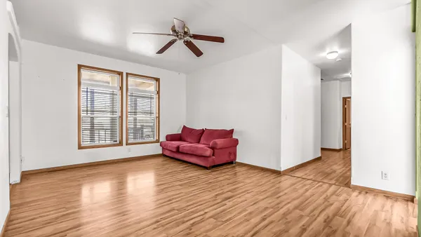 a living room with furniture and wooden floor
