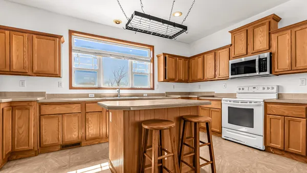 a kitchen with stainless steel appliances granite countertop a stove sink microwave and cabinets