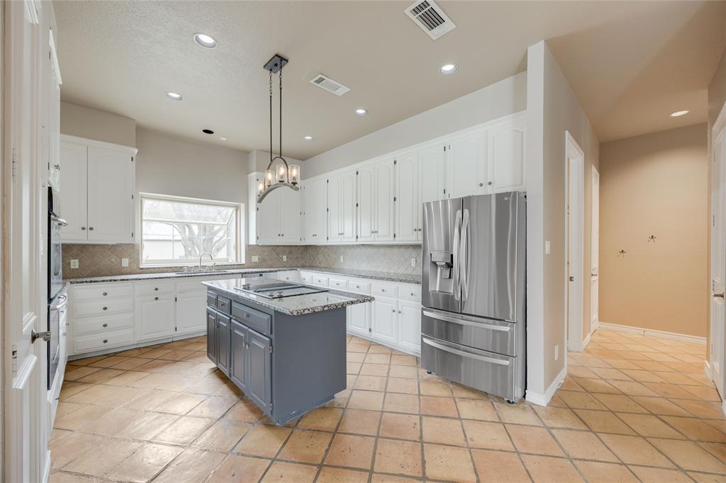 1201 Findlay Drive Arlington, TX 76012 - Photo 15 of 35 a kitchen with kitchen island granite countertop a refrigerator oven a sink and a counter