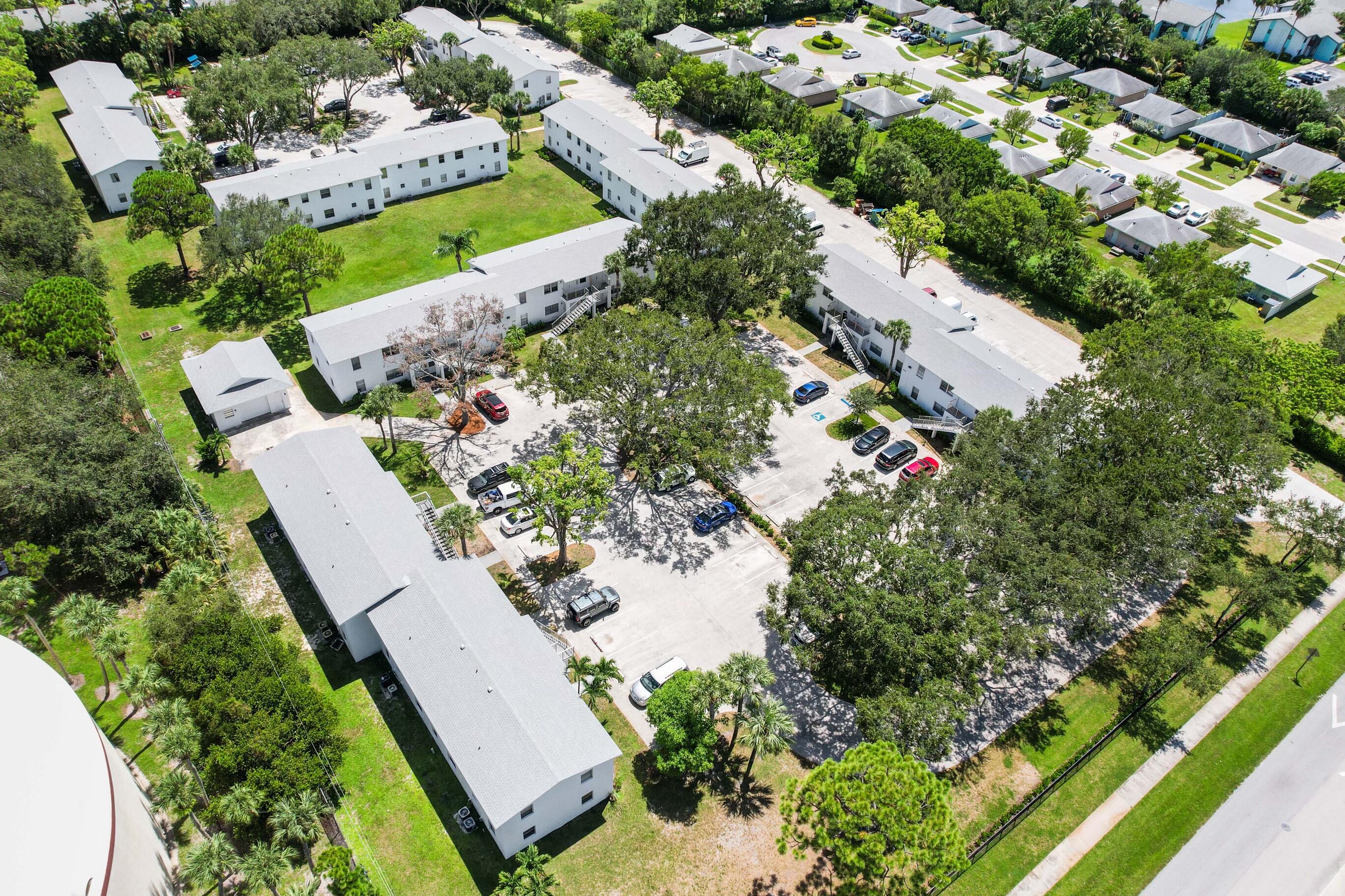 6610 Jupiter Gardens Boulevard, Unit F Jupiter, FL 33458 - Photo 14 of 14 an aerial view of a house with a yard and lake view