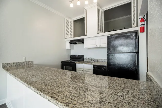 a kitchen with a refrigerator and a sink