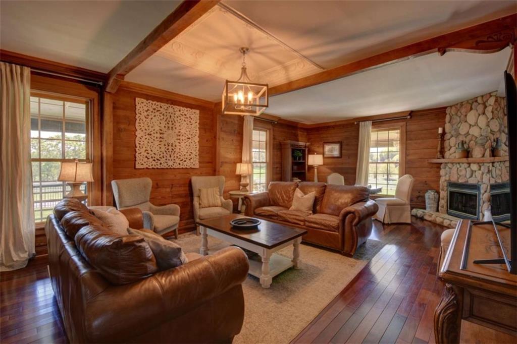 7527 Highway 326 Commerce, GA 30530 - Photo 11 of 57 a living room with furniture a fireplace and wooden floor