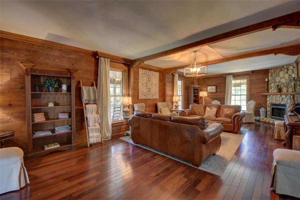 7527 Highway 326 Commerce, GA 30530 - Photo 12 of 57 a living room with furniture a large window and wooden floor