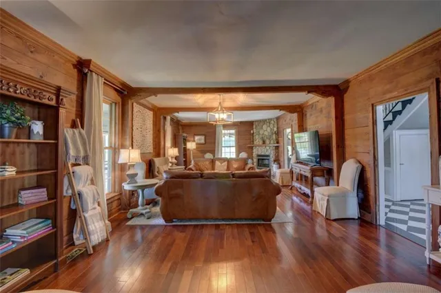 a spacious bedroom with a bed and wooden floor