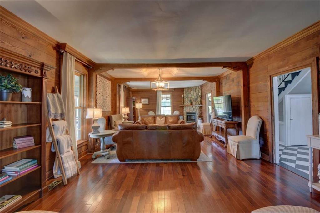 7527 Highway 326 Commerce, GA 30530 - Photo 13 of 57 a living room with fireplace furniture and a wooden floor