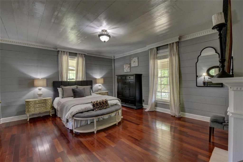7527 Highway 326 Commerce, GA 30530 - Photo 16 of 57 a spacious bedroom with a bed and wooden floor
