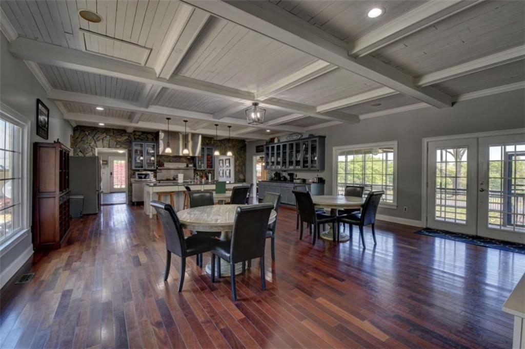 7527 Highway 326 Commerce, GA 30530 - Photo 20 of 57 a dining room with furniture window wooden floor and a rug
