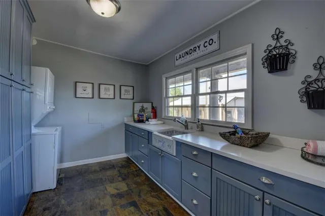 a bedroom with a bed a couch and a flat tv screen on the dresser