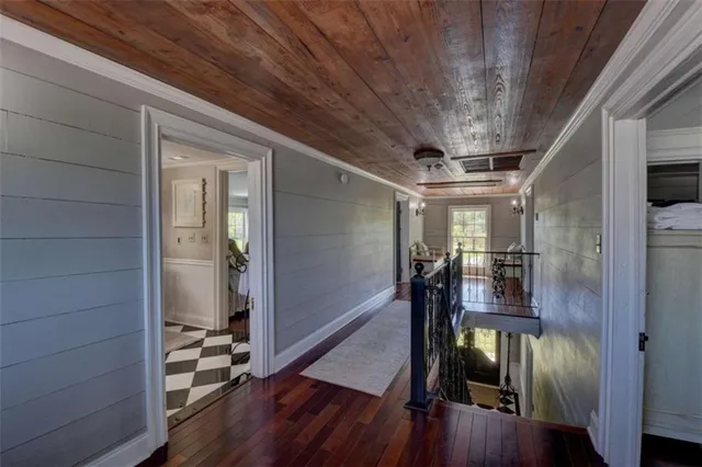 a bedroom with furniture and a wooden floor