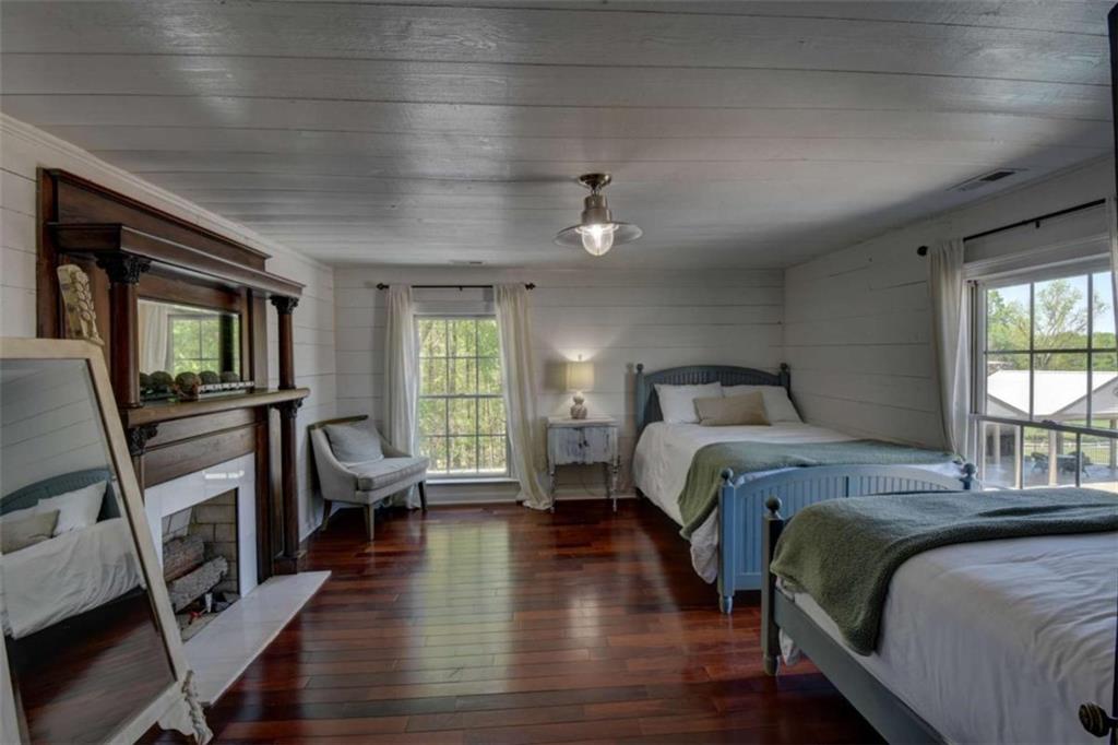 7527 Highway 326 Commerce, GA 30530 - Photo 30 of 57 a bedroom with a bed a couch and a flat tv screen on the dresser