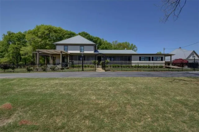 a house with green field in front of it