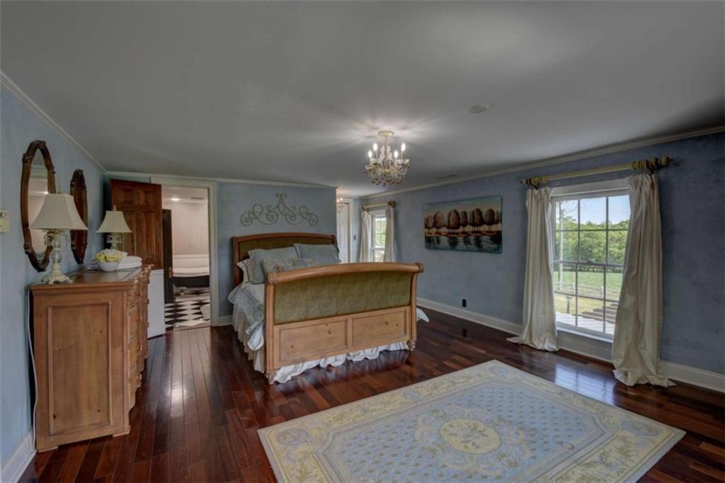 7527 Highway 326 Commerce, GA 30530 - Photo 32 of 57 a bedroom with furniture and a wooden floor