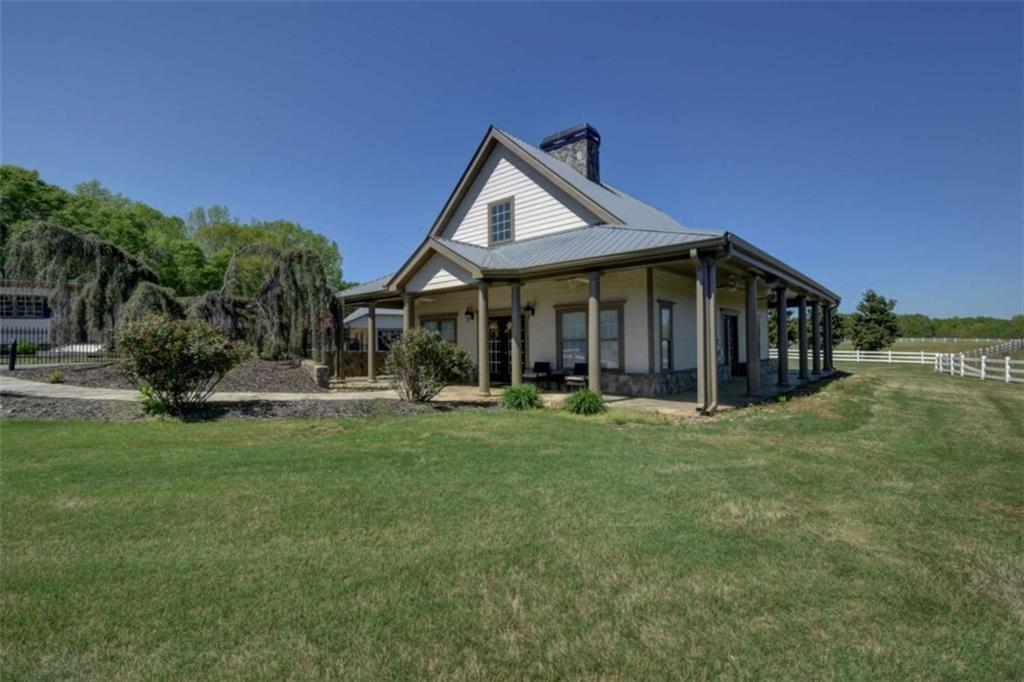 7527 Highway 326 Commerce, GA 30530 - Photo 36 of 57 a front view of a house with a garden and porch