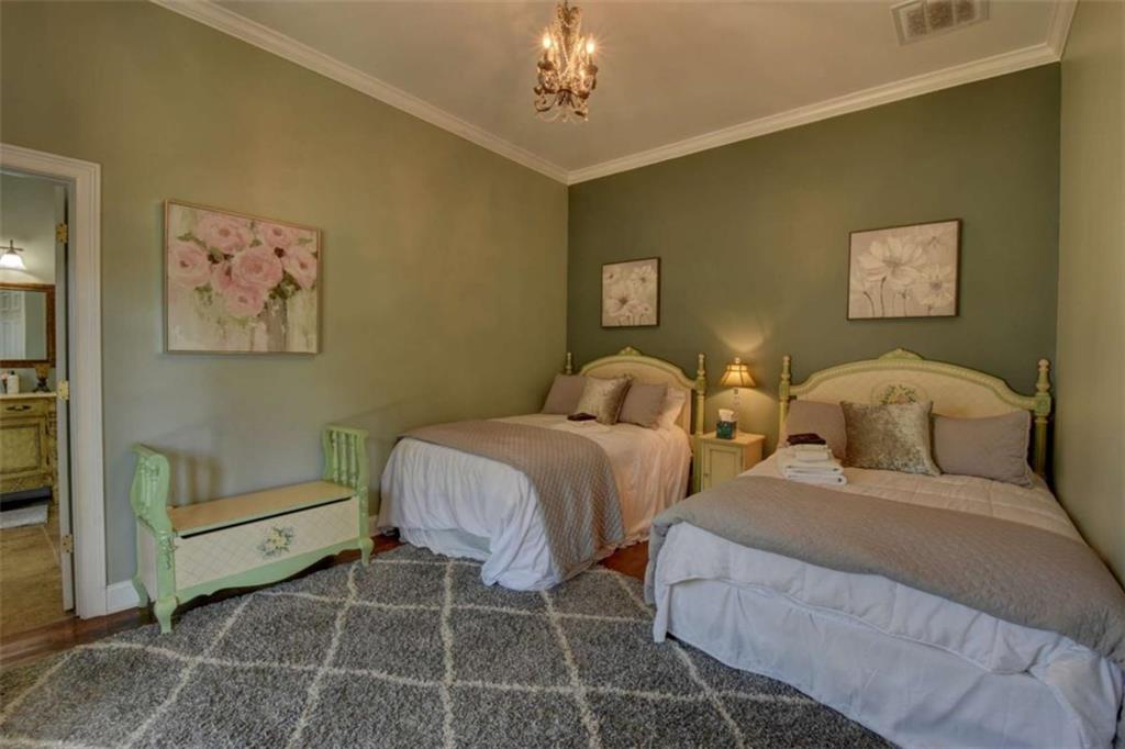 7527 Highway 326 Commerce, GA 30530 - Photo 39 of 57 a bedroom with two beds and a chandelier