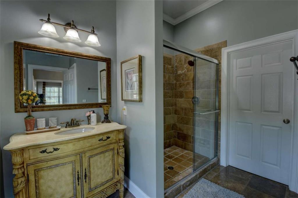7527 Highway 326 Commerce, GA 30530 - Photo 40 of 57 a bathroom with a shower sink and mirror
