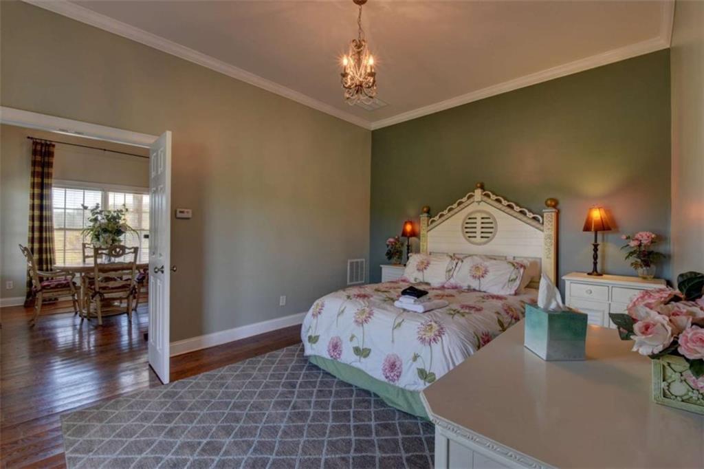 7527 Highway 326 Commerce, GA 30530 - Photo 42 of 57 a bedroom with bed and wooden floor