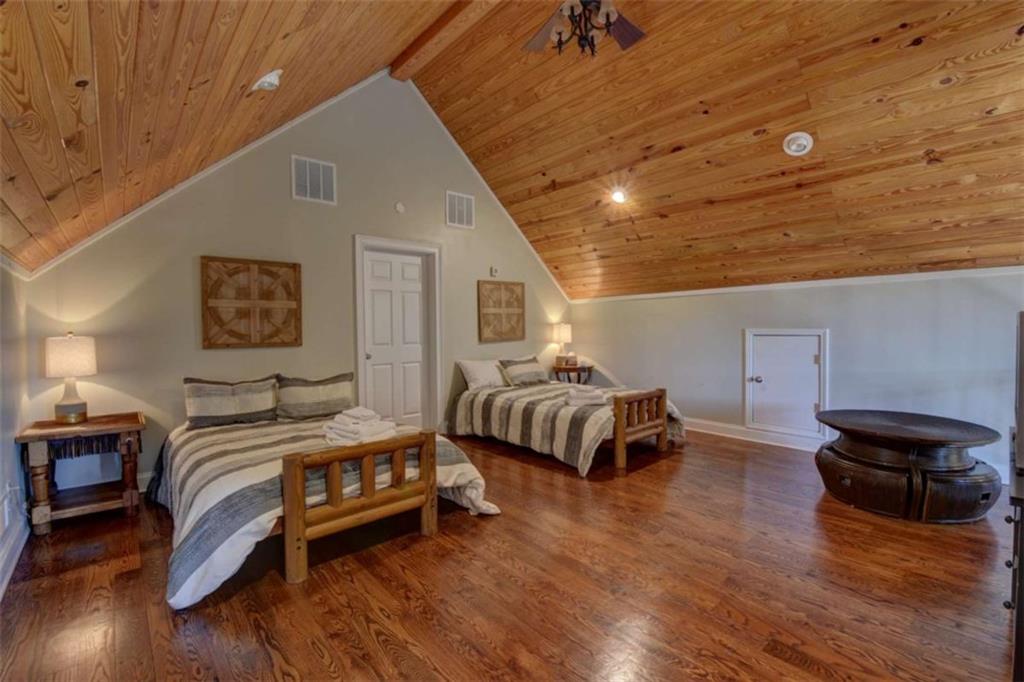 7527 Highway 326 Commerce, GA 30530 - Photo 44 of 57 a bedroom with a bed and wooden floor