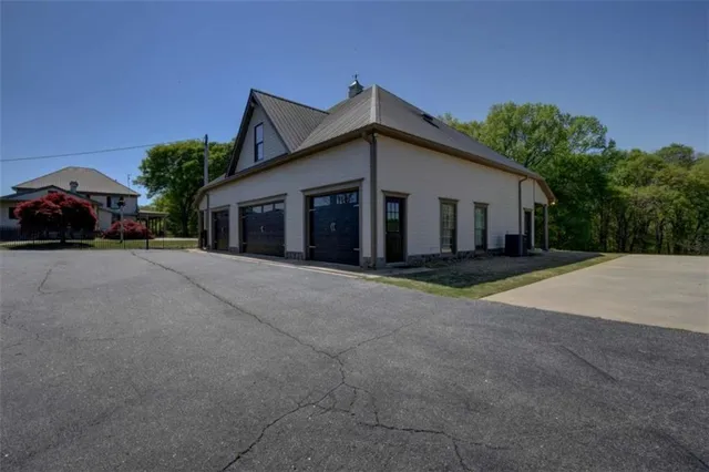 a living room with furniture a flat screen tv and a floor to ceiling window