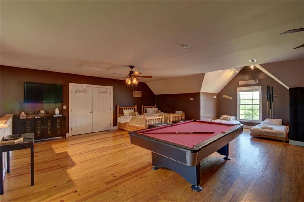 7527 Highway 326 Commerce, GA 30530 - Photo 53 of 57 a living room with furniture a flat screen tv and a floor to ceiling window