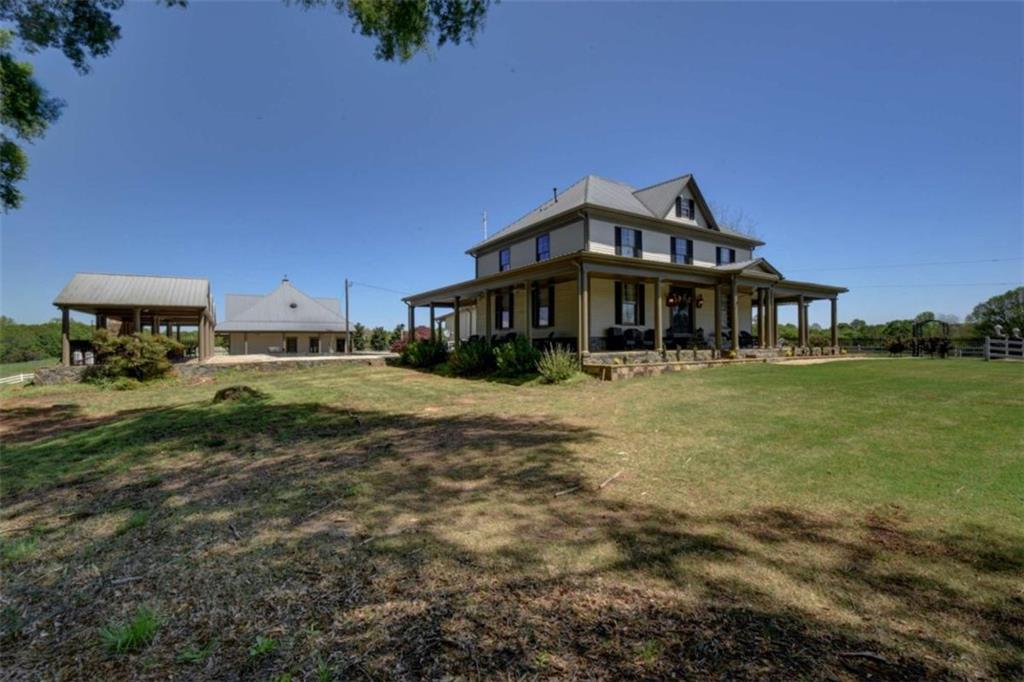7527 Highway 326 Commerce, GA 30530 - Photo 7 of 57 a front view of a house with a yard